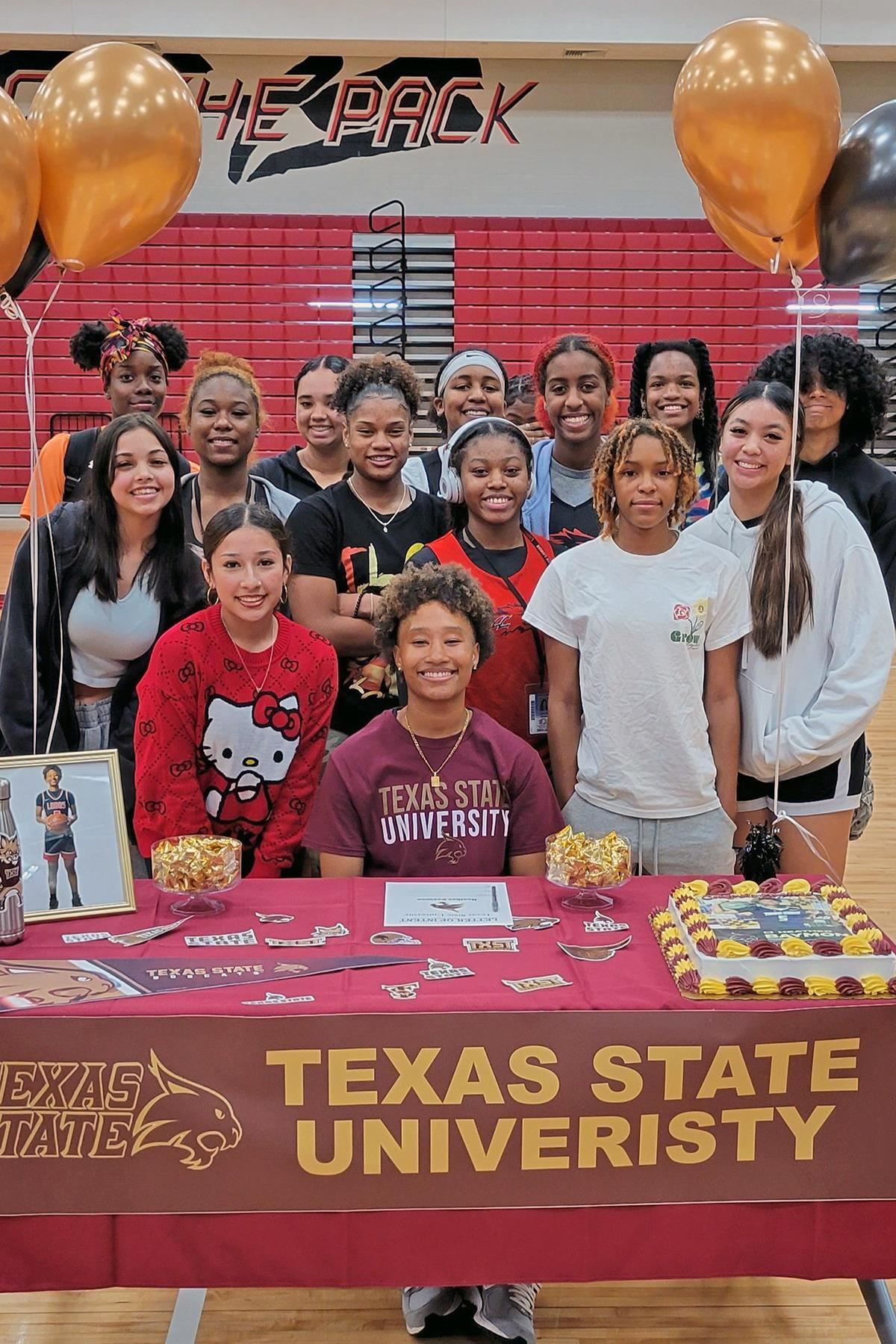 Langham Creek High School senior Heather Baymon, seated, signed her letter of intent to play basketball at Texas State.